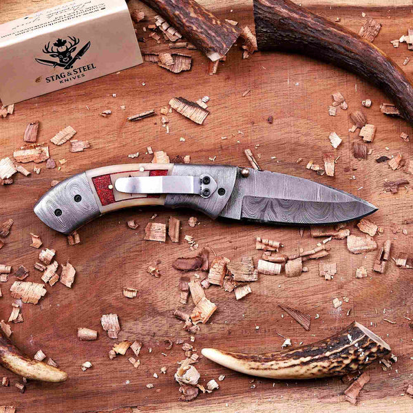 Damascus folding knife with stainless steel pocket clip and camel bone Canada flag handle