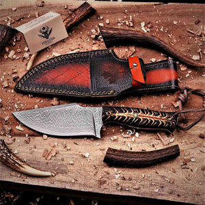 Handmade Damascus hunting knife with maple leaf pin and Stag Steel Knives care card