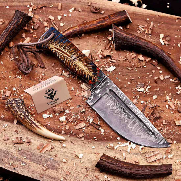Damascus skinning knife with pine cone resin handle and copper skull pin