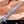 Detailed shot of hand-forged Damascus steel blade showing double finger guard, ricasso pattern, and sharp clip point edge