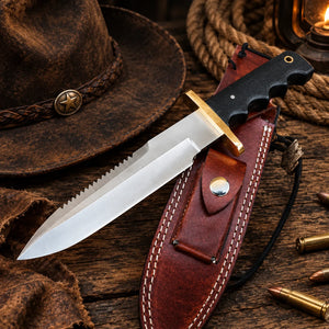 Diver D2 sawback bowie knife with red Micarta handle and brass guard on dark wood Copy