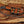 Brown dual-wear leather sheath for handmade D2 tracker knife with black Micarta handle and brass snap straps