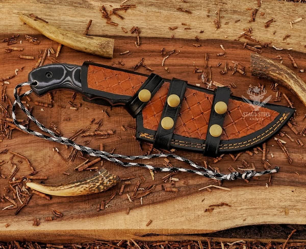 Brown dual-wear leather sheath for handmade D2 tracker knife with black Micarta handle and brass snap straps