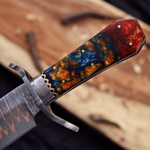 exotic resin handle close up on handmade Bowie knife