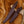 Two brown leather knife sheaths on a deer antler against a fur background