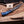 Finger guard Damascus bowie knife displayed on rustic workbench with antlers