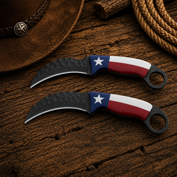 Two curved folding knives with Texas flag-patterned handles are displayed on a rustic wooden surface alongside a brown hat and rope.