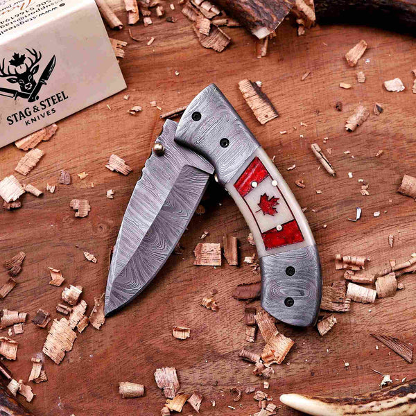 Folding pocket knife with handmade Canada flag handle and Damascus steel blade