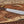 Full tang D2 machete knife with Ironwood handle, satin blade, and paracord on wood background