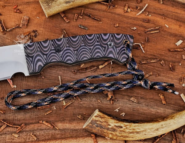 Close-up of Grey Micarta handle on full tang D2 steel machete knife with handle pins and paracord