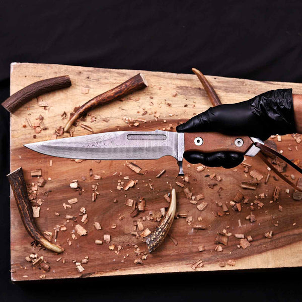 Handmade Damascus bowie knife held by the micarta handle