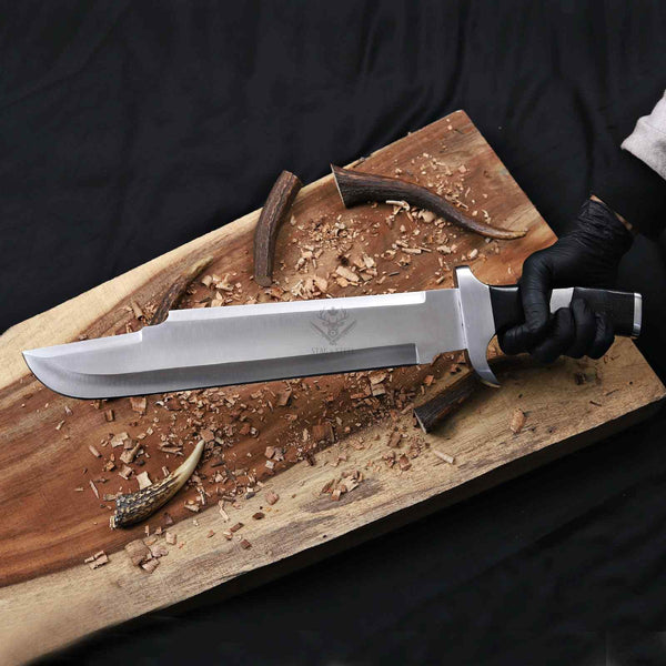 handmade D2 steel bowie knife held in hand showing full blade