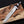 Handmade D2 steel bowie knife with black Micarta handle on rustic wood