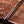 Hand-forged D2 bowie knife sawback spine and fuller close-up