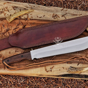 Handmade D2 machete knife with Ironwood handle, satin blade, brown leather sheath, and paracord on rustic wood background