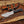 Handmade D2 tracker knife with black Micarta handle, mirror polished blade, brown dual-wear leather sheath, and paracord