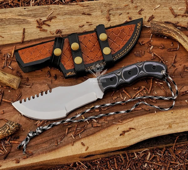 Handmade D2 tracker knife with black Micarta handle, mirror polished blade, brown dual-wear leather sheath, and paracord