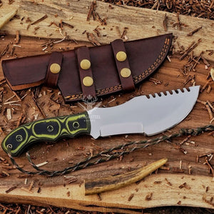 Handmade D2 tracker knife with Micarta handle shown beside brown leather sheath with horizontal and vertical carry straps