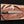 Handmade Damascus toothpick bowie knife with brass spine on wooden board