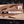 Handmade Expendables toothpick bowie knife with brass spine on wooden board