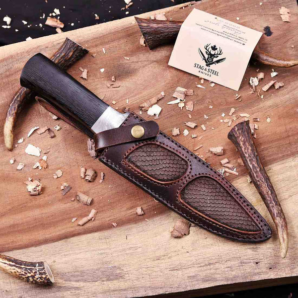 Damascus hunting knife seated in  Italian leather sheath