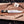 Full profile of Iron Mistress D2 bowie knife with brass spine on wooden board