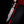 Iron Mistress Damascus bowie knife with brass spine held against black background