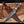Juan Padillo Damascus Bowie knife and brown leather sheath crossed on a wooden plank
