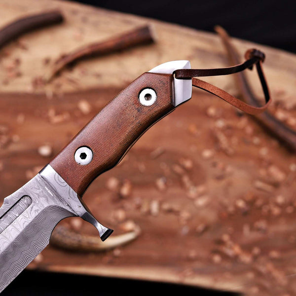 Brown micarta handle and forged Damascus guard with leather lanyard on bowie knife