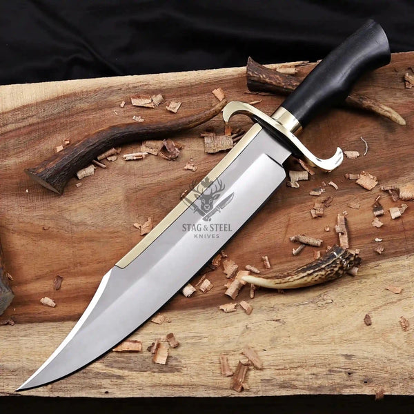 Musso bowie knife showing D2 steel sweeping clip point blade and brass back strap