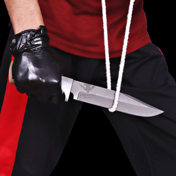 Ridgeback D2 full tang knife held beside rope in cutting test