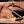 Hand holding San Mai Damascus hunting knife showing blade (spine) profile