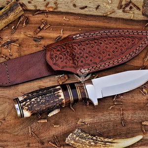Small hunting knife with D2 steel blade and stag horn handle with leather sheath