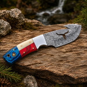 A custom outdoor knife with a patterned Damascus steel blade and a colorful handle, resting on a weathered log with a forest and waterfall background.