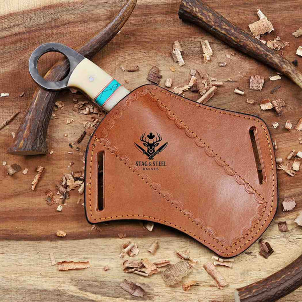Leather knife sheath with 'Stag & Steel Knives' logo on a wooden background with a knife.