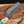 Close-up of a Damascus steel knife with a wooden handle on a blurred background