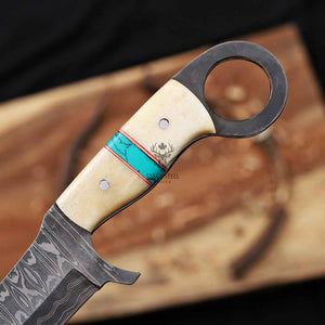 Decorative knife with a detailed handle on a wooden surface