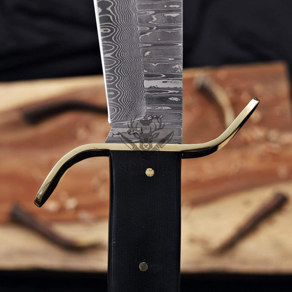 Polished brass S-guard on a handmade western bowie knife