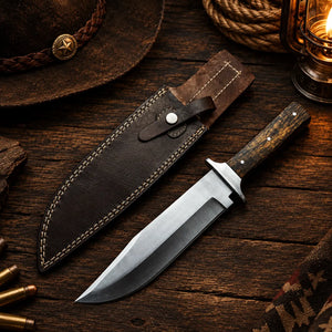 Handmade Western Bowie knife with 10 inch stainless clip point and wood handle beside a leather sheath