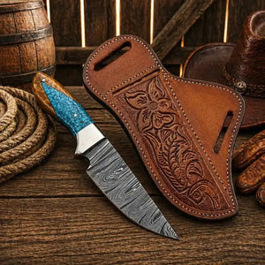 Knife with turquoise handle and Damascus blade in a brown leather sheath on a wooden surface.